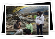 Locals sitting down amongst the rubble